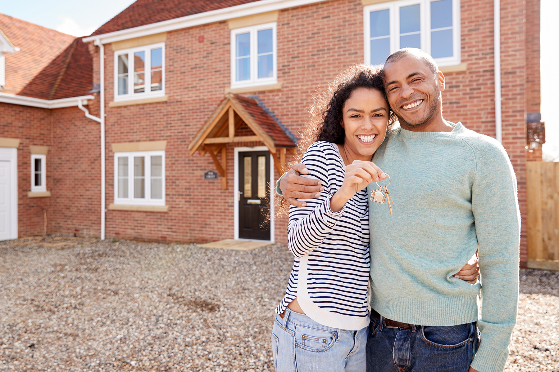 Couple at front door with keys